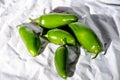 Five green hot jalapeno peppers